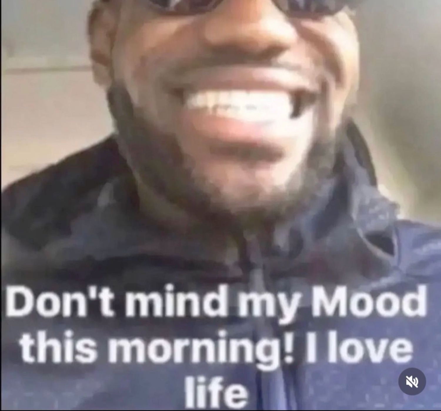 Man in sunglasses grinning ear to ear captioned 'Don't mind my Mood this morning! I love life'