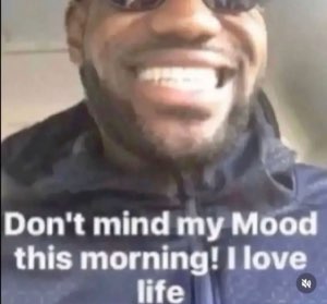 Man in sunglasses grinning ear to ear captioned 'Don't mind my Mood this morning! I love life'
