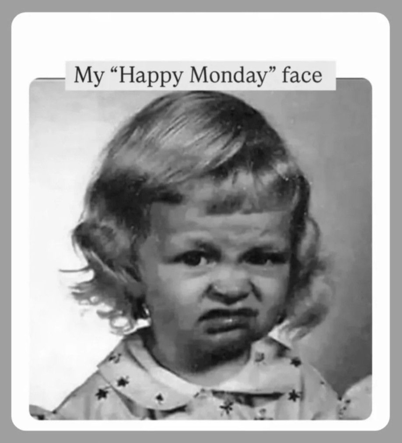 Black-and-white toddler grimacing under 'My "Happy Monday" face'