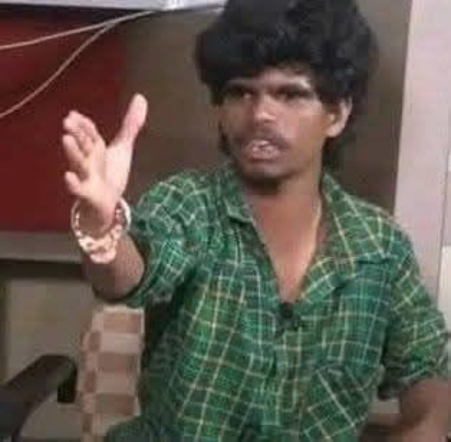 Man gesturing mid-argument with a raised hand