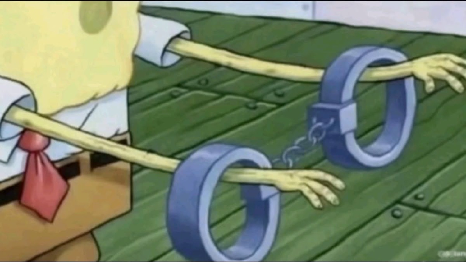 SpongeBob's arms reaching out of a pair of open handcuffs on the dock