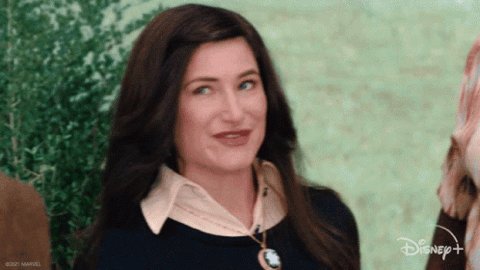 Woman laughing and giving a cheeky wink