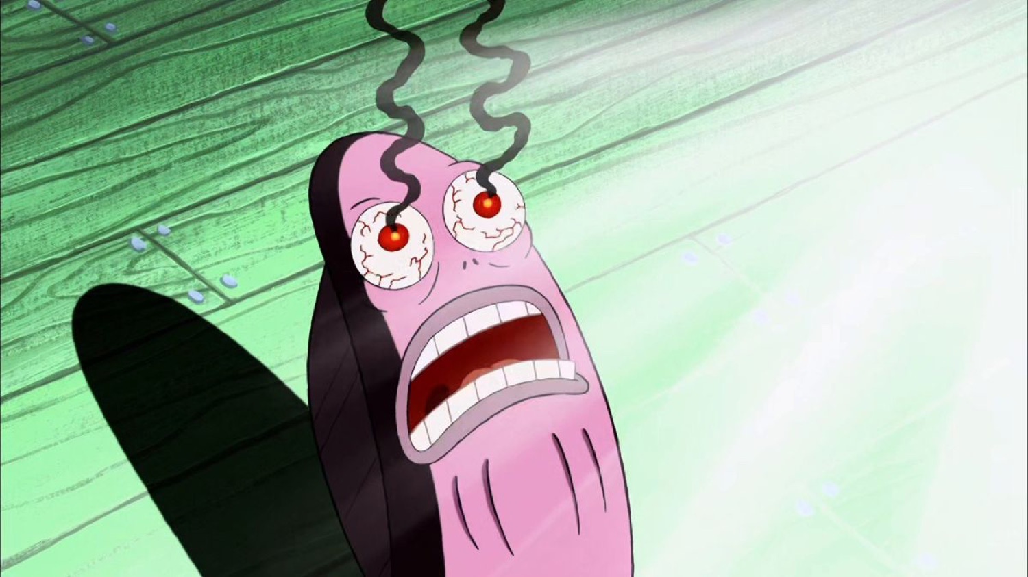 Pink fish with bloodshot eyes recoiling in horror