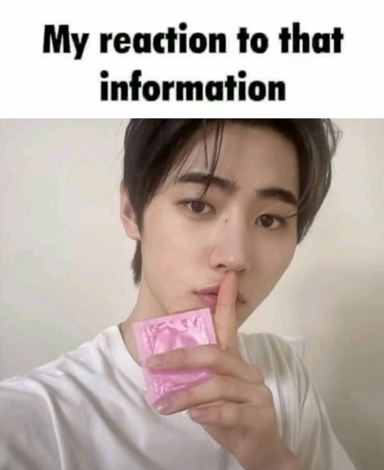 Man holding a finger to his lips, text reads 'My reaction to that information'
