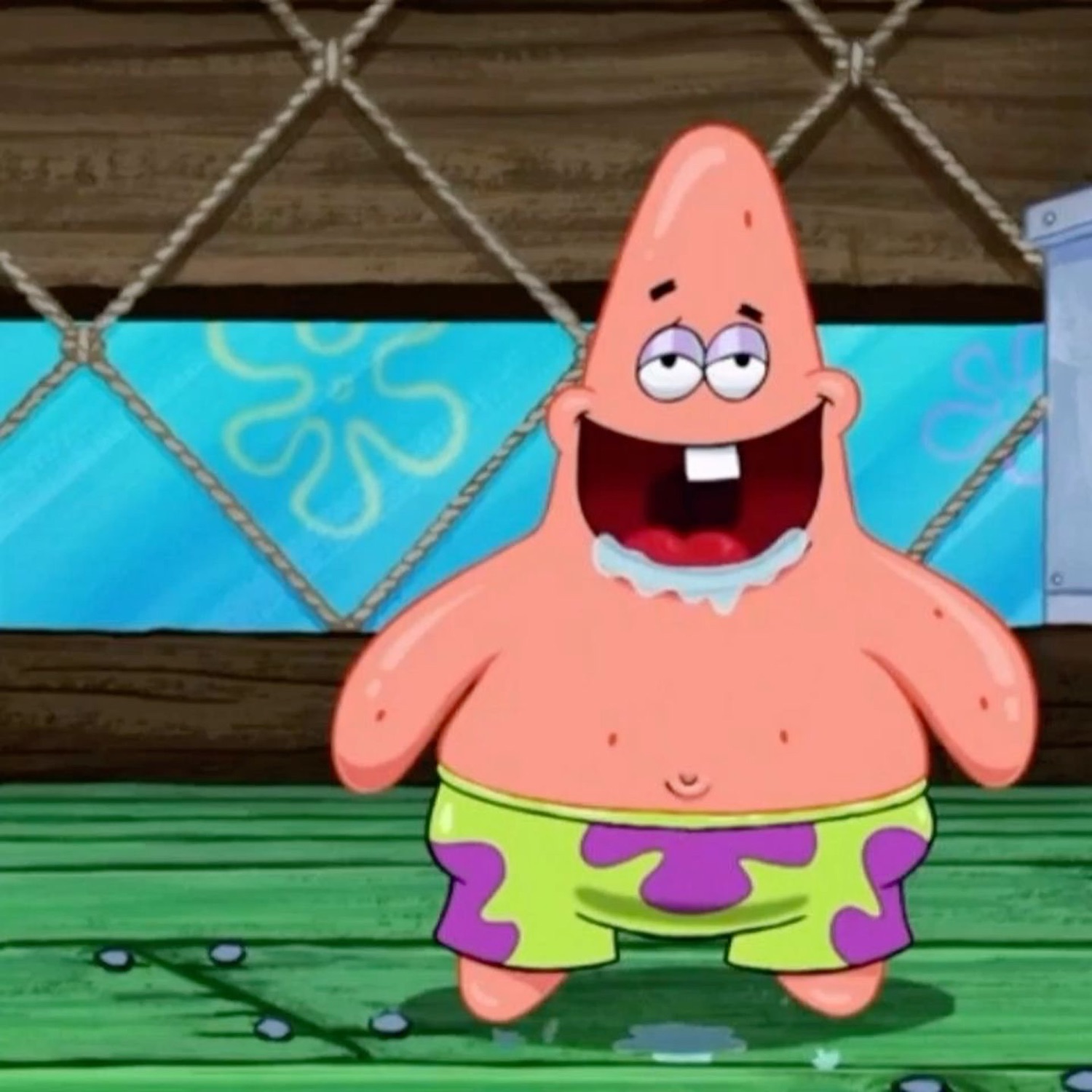 Patrick Star standing in a puddle of his own drool, mouth wide open in dopey glee