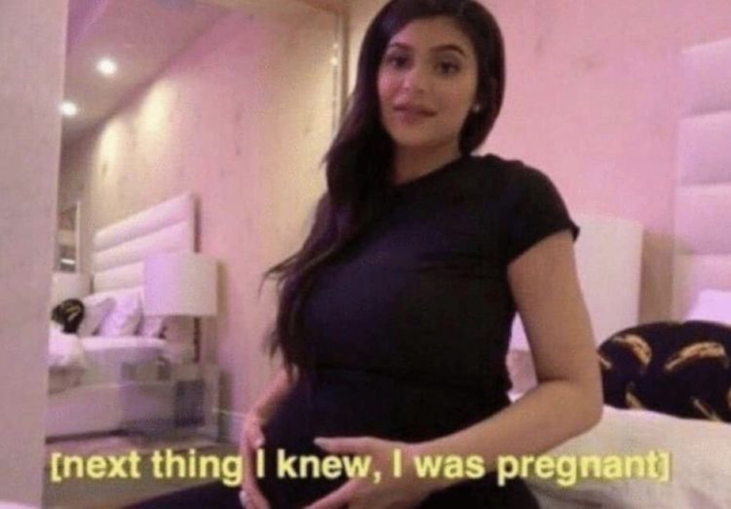 Woman cradling her pregnant belly captioned '[next thing I knew, I was pregnant]'