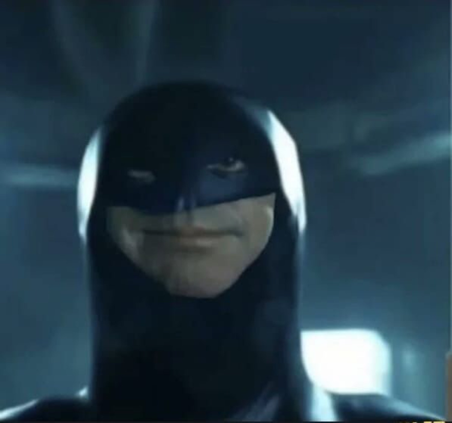 Batman in costume giving a subtle, knowing smirk directly at the camera