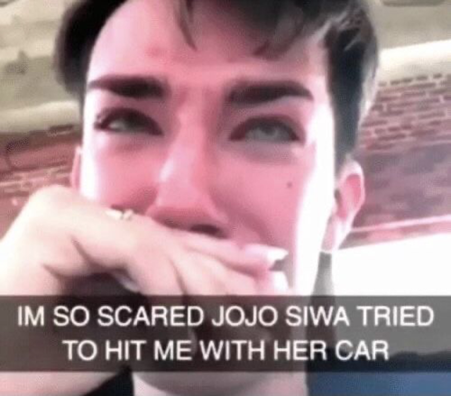 Tearful person covering their mouth, captioned about Jojo Siwa trying to hit them with a car