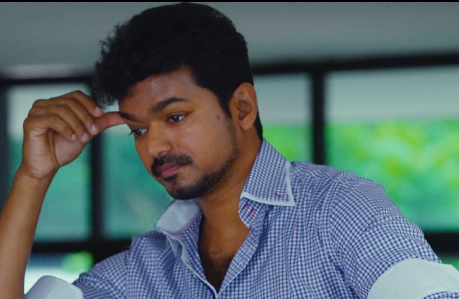 Vijay rubbing his forehead with a tired look