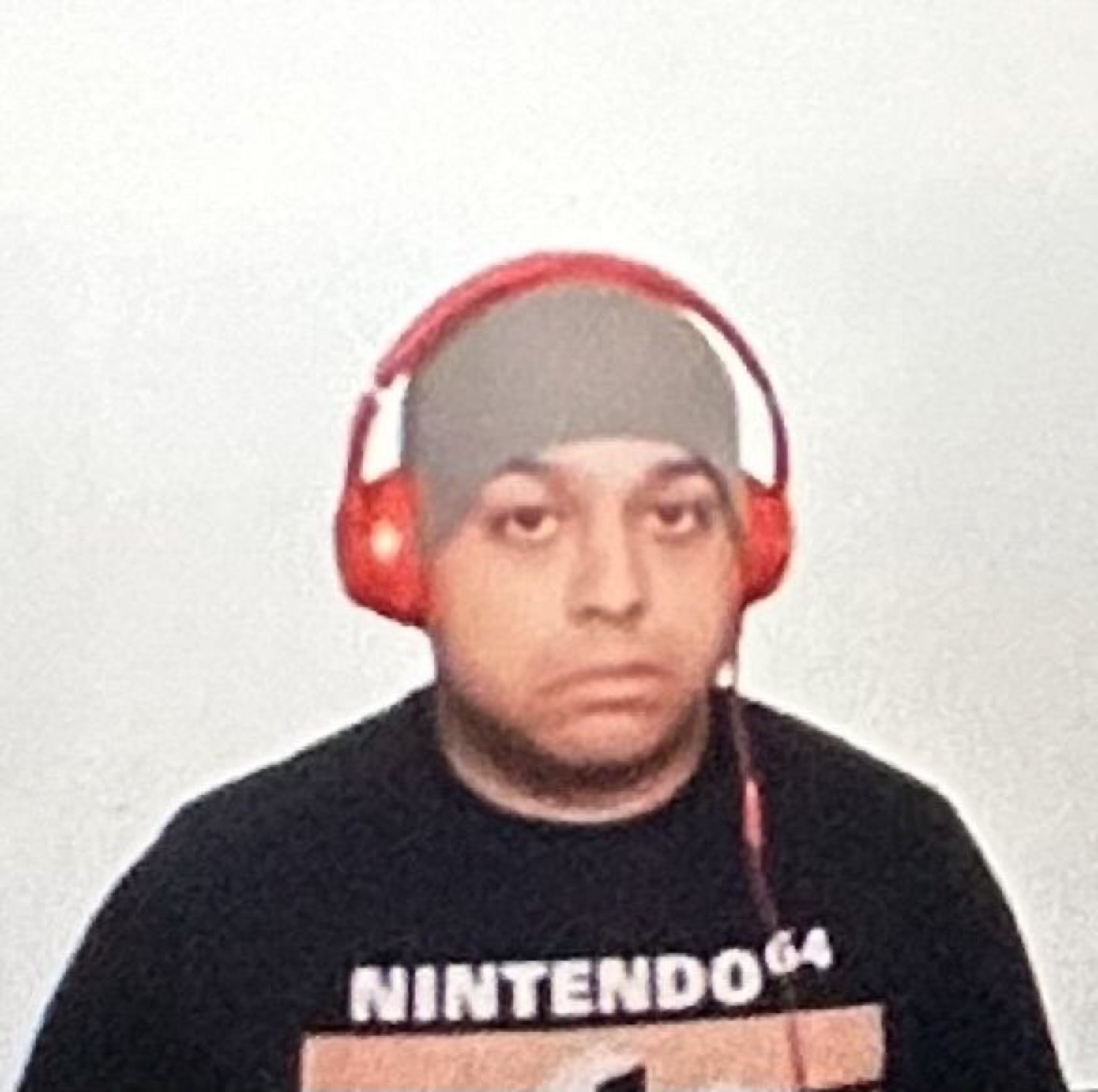 Guy in a Nintendo 64 shirt and red headphones staring at you with zero energy