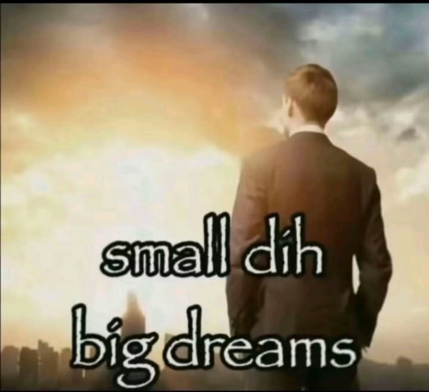 Suited man gazing at a glowing city skyline captioned 'small dih big dreams'