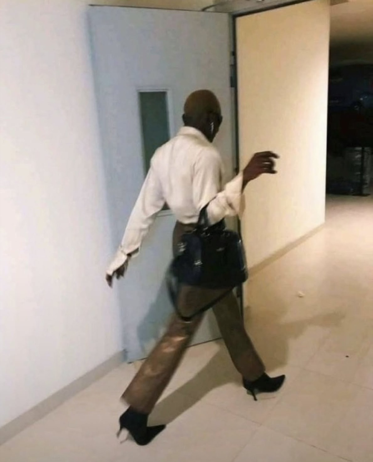 Man in a suit strutting out in high heels