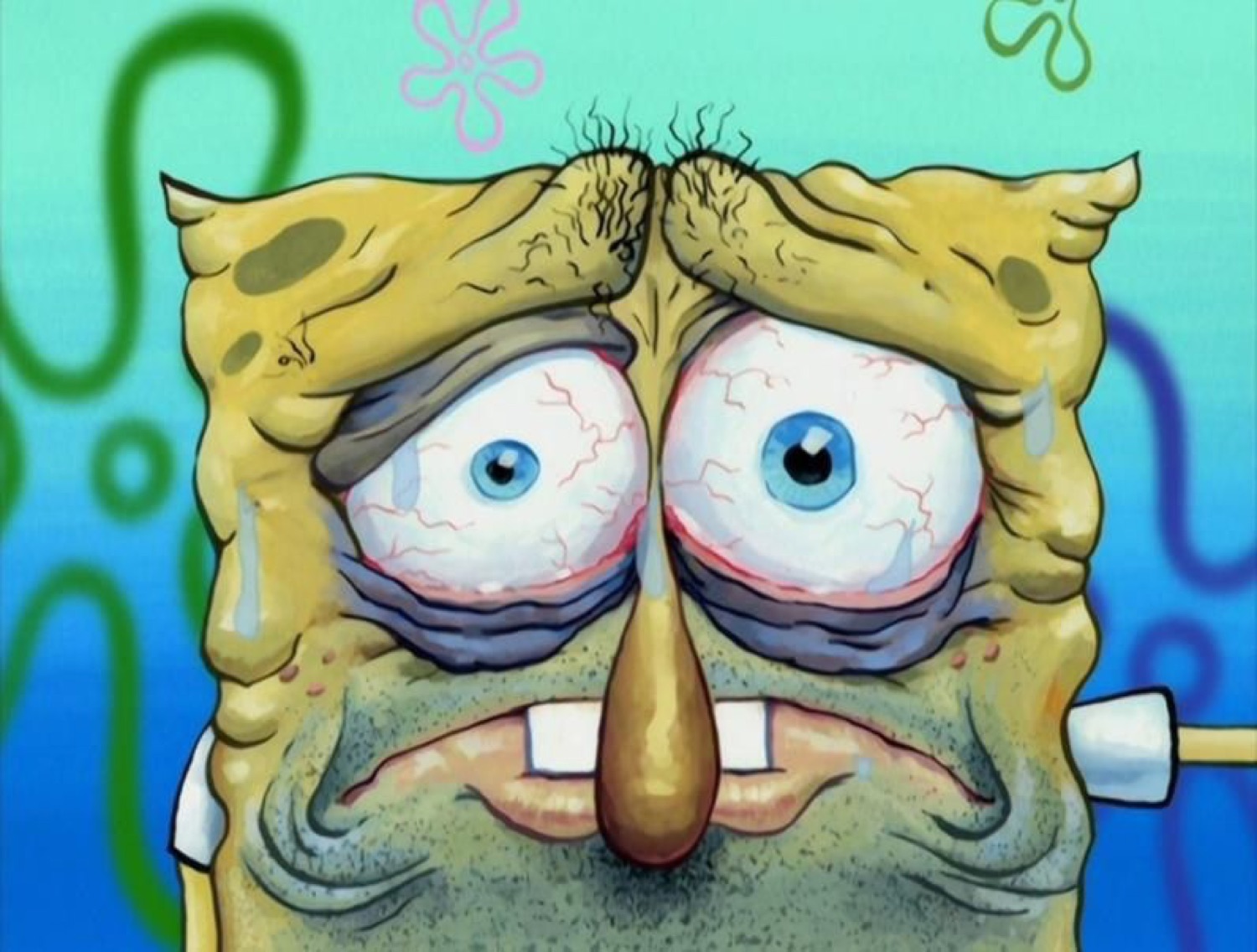 SpongeBob with bloodshot bulging eyes, wrinkles and a frazzled, exhausted face