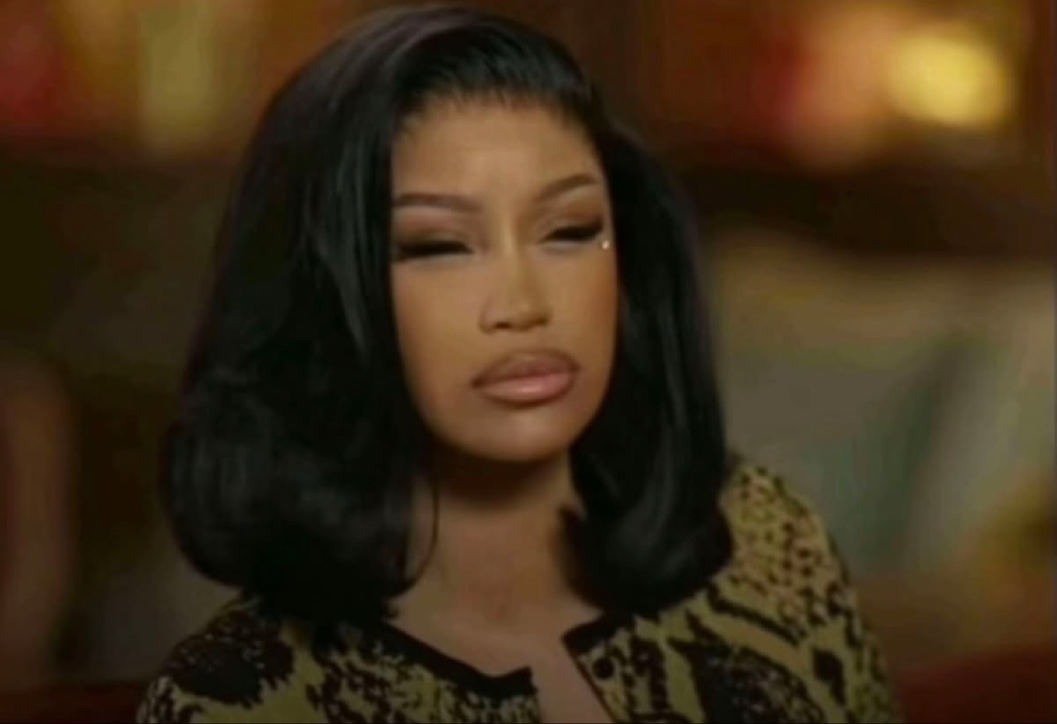 Woman with a sleek bob glancing sideways with a skeptical, unimpressed look