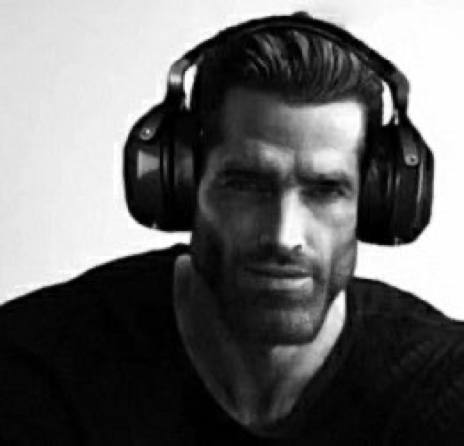 Gigachad wearing gaming headphones in black and white