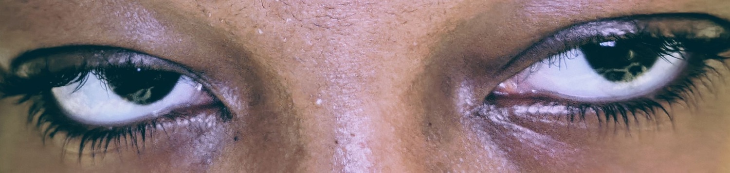 Extreme close-up of a person's eyes glancing sideways in suspicion