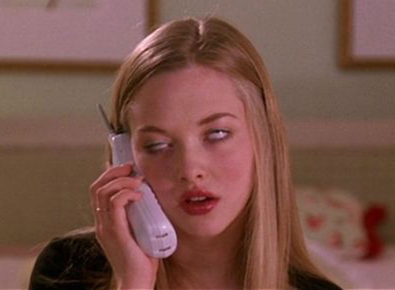 Blonde woman on the phone throwing serious side-eye with a slightly open mouth