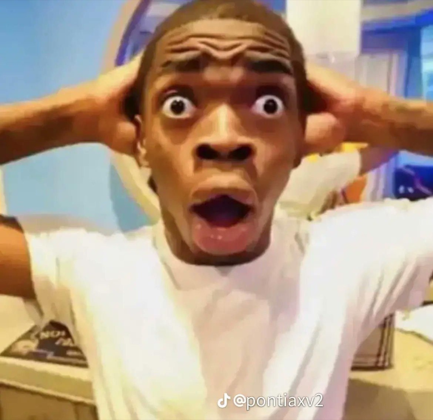 Man clutching his head with bulging eyes and mouth agape in total shock