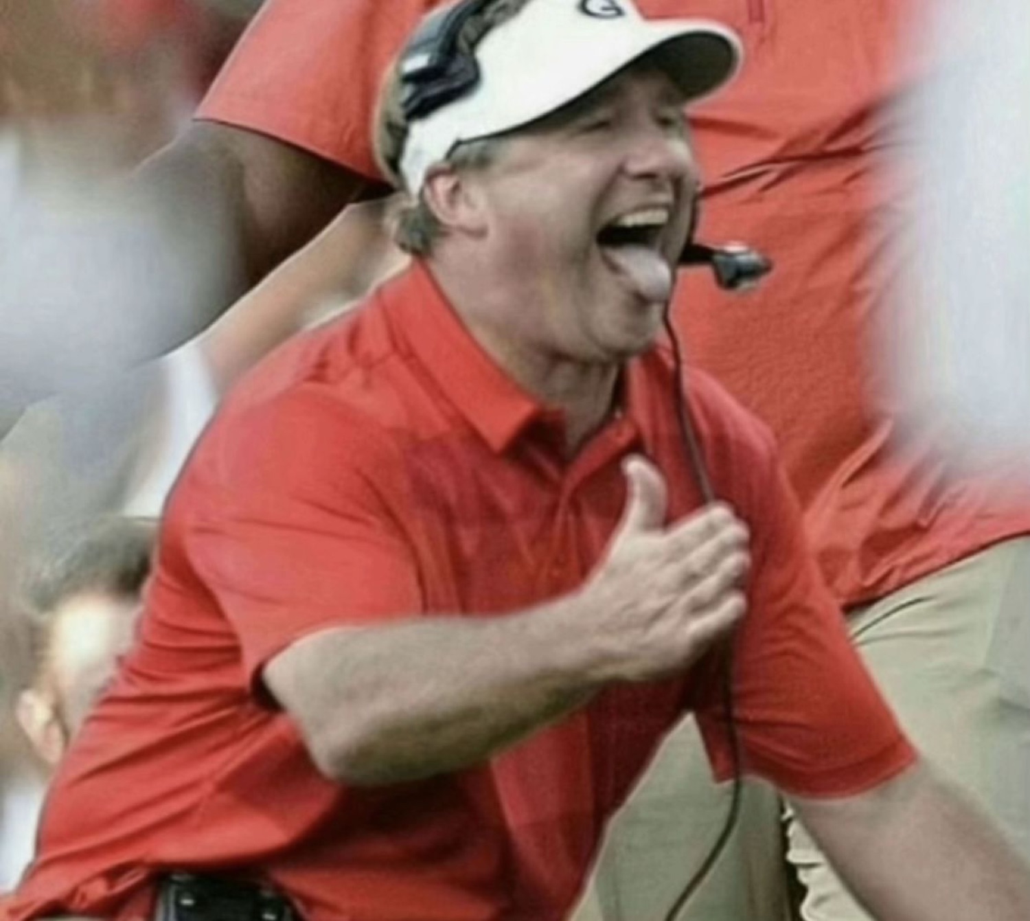 Football coach in a red shirt screaming with joy, tongue out