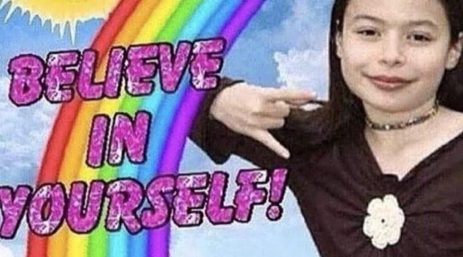 Girl smirking as she points at a glittery rainbow 'BELIEVE IN YOURSELF!' graphic