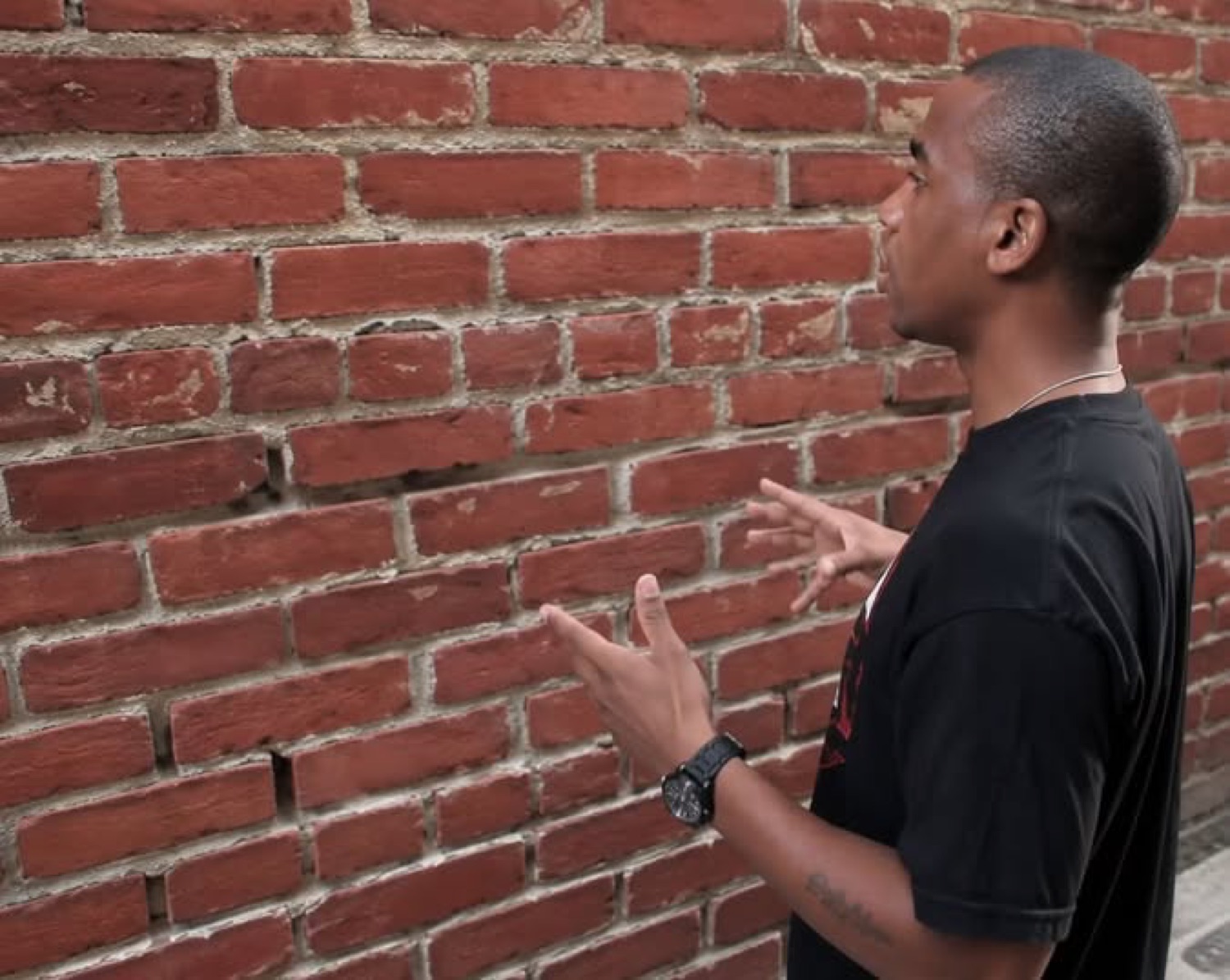 Man explaining something to a brick wall