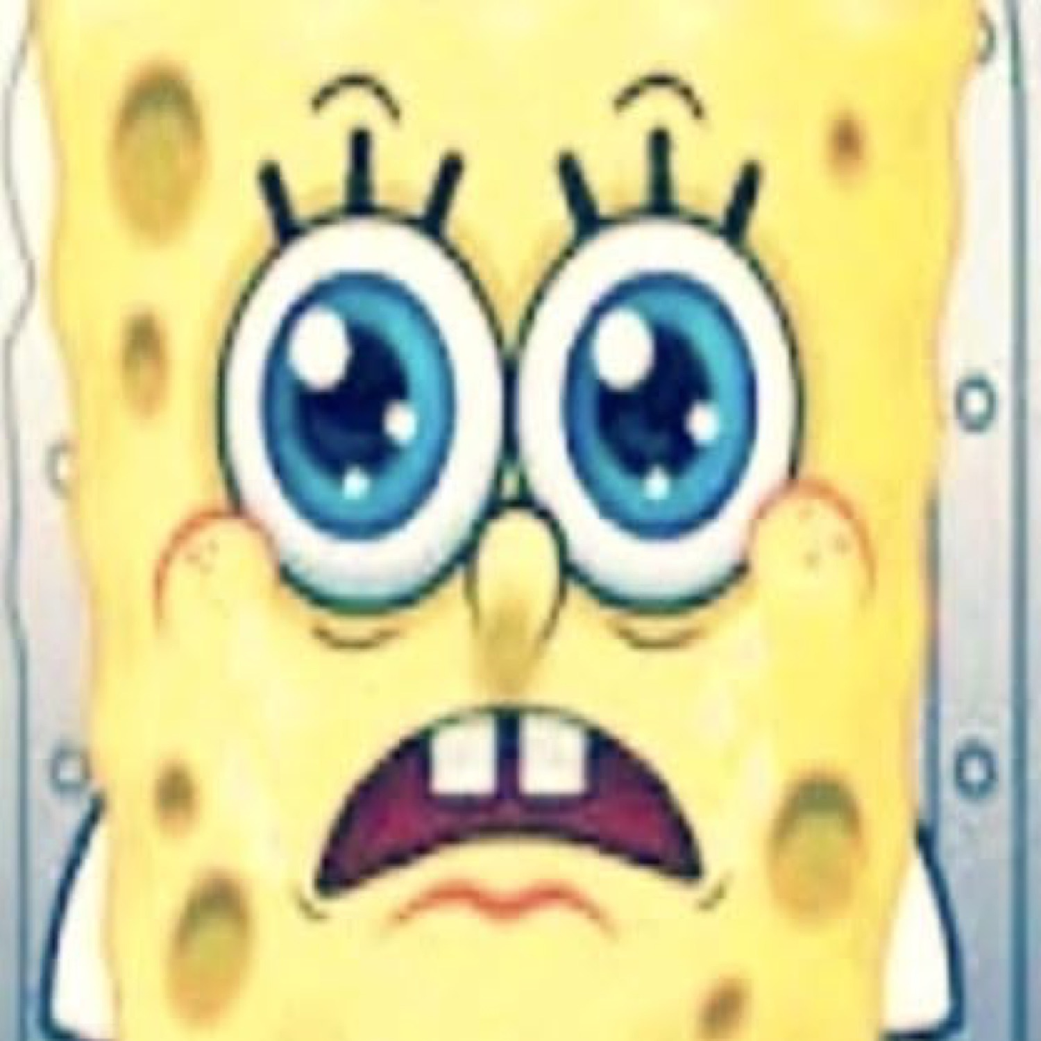 Extreme close-up of SpongeBob with huge worried eyes and a trembling frown