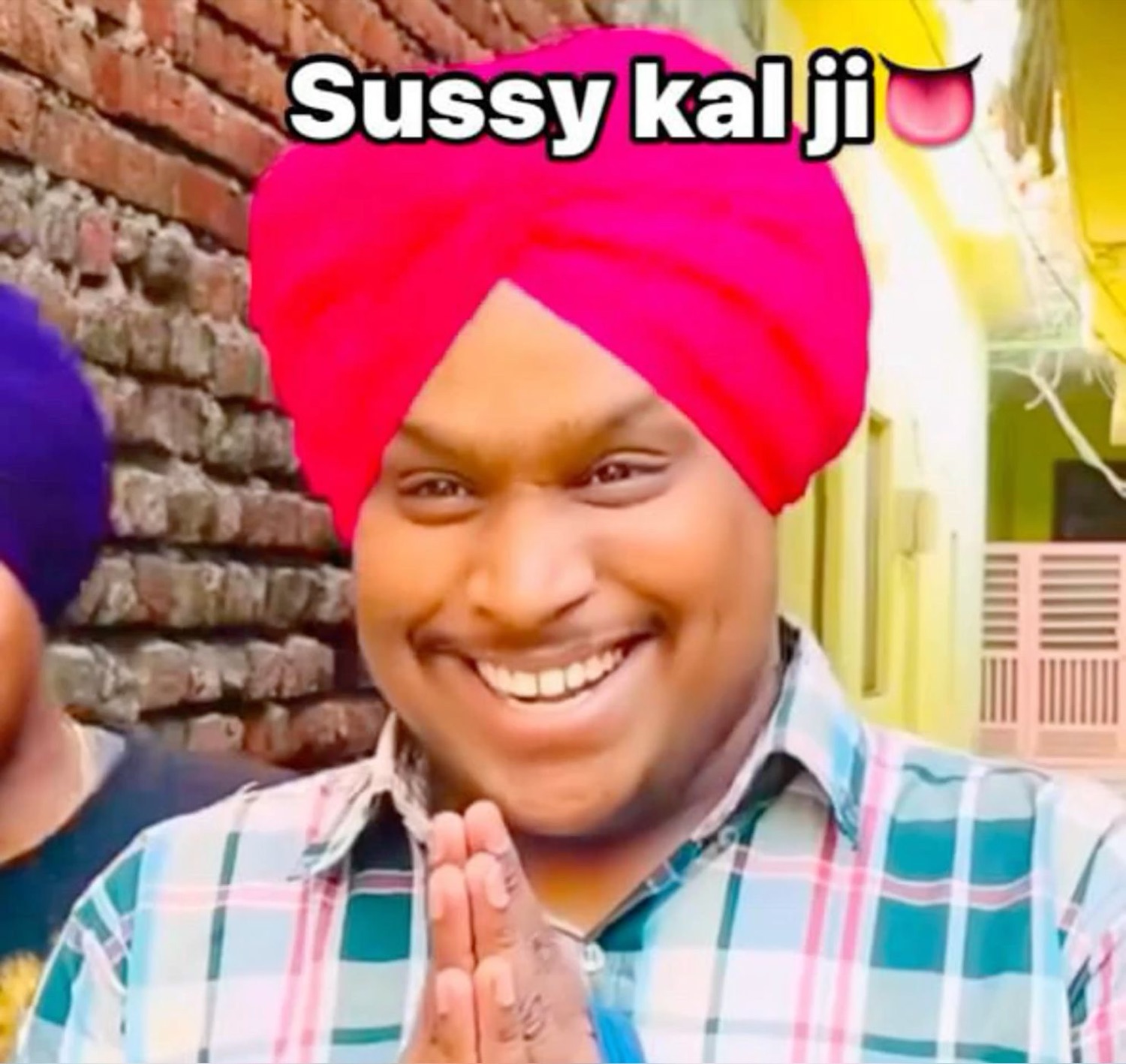 Grinning man in a pink turban with hands folded: 'Sussy kal ji'