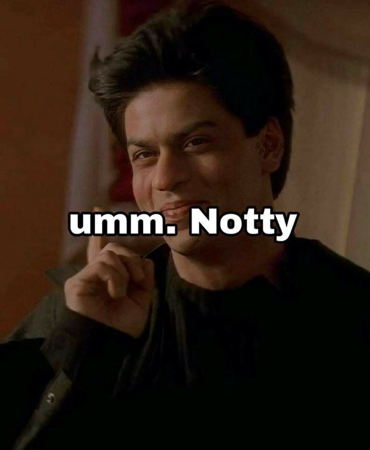 Shah Rukh Khan smirking with a hand on his chin: 'umm. Notty'