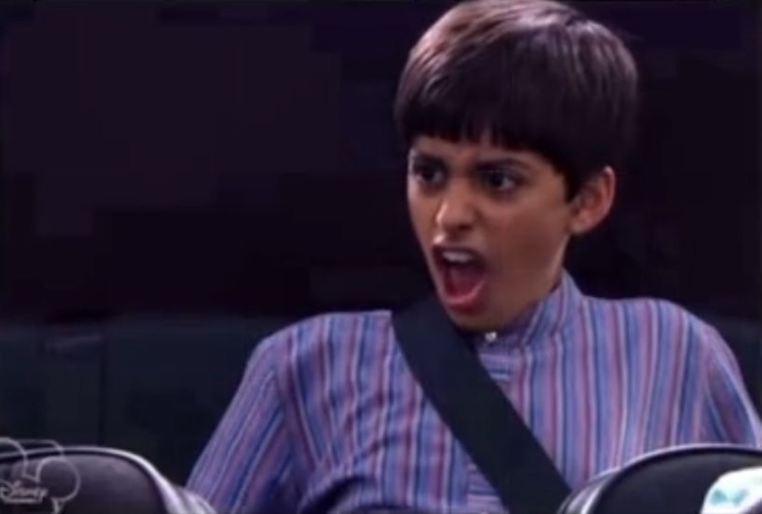 Kid on a theme park ride mouth wide open in shocked disbelief