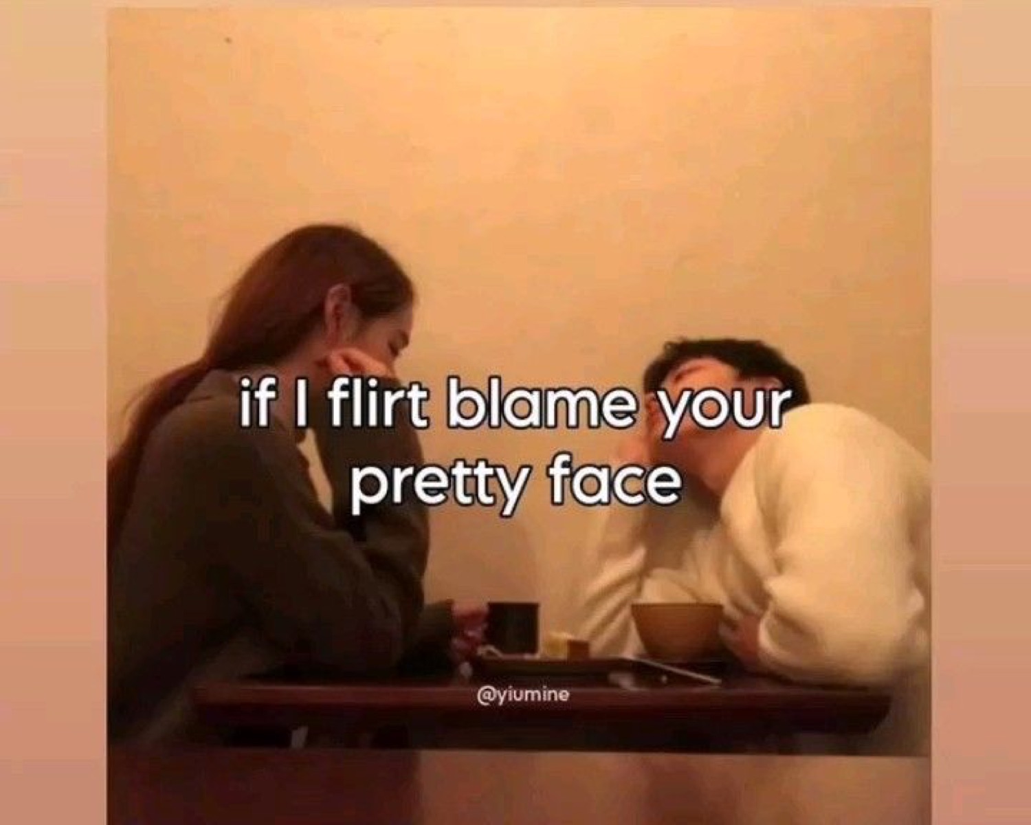Couple at a cafe table both hiding their faces, captioned 'if I flirt blame your pretty face'