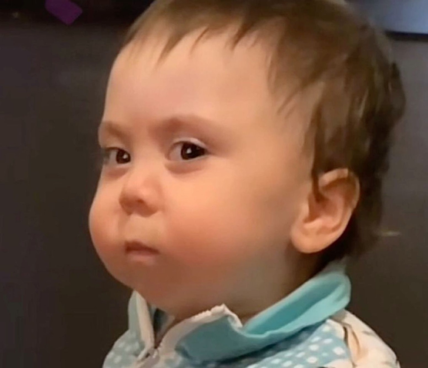 Toddler giving a skeptical, unimpressed side glance off camera