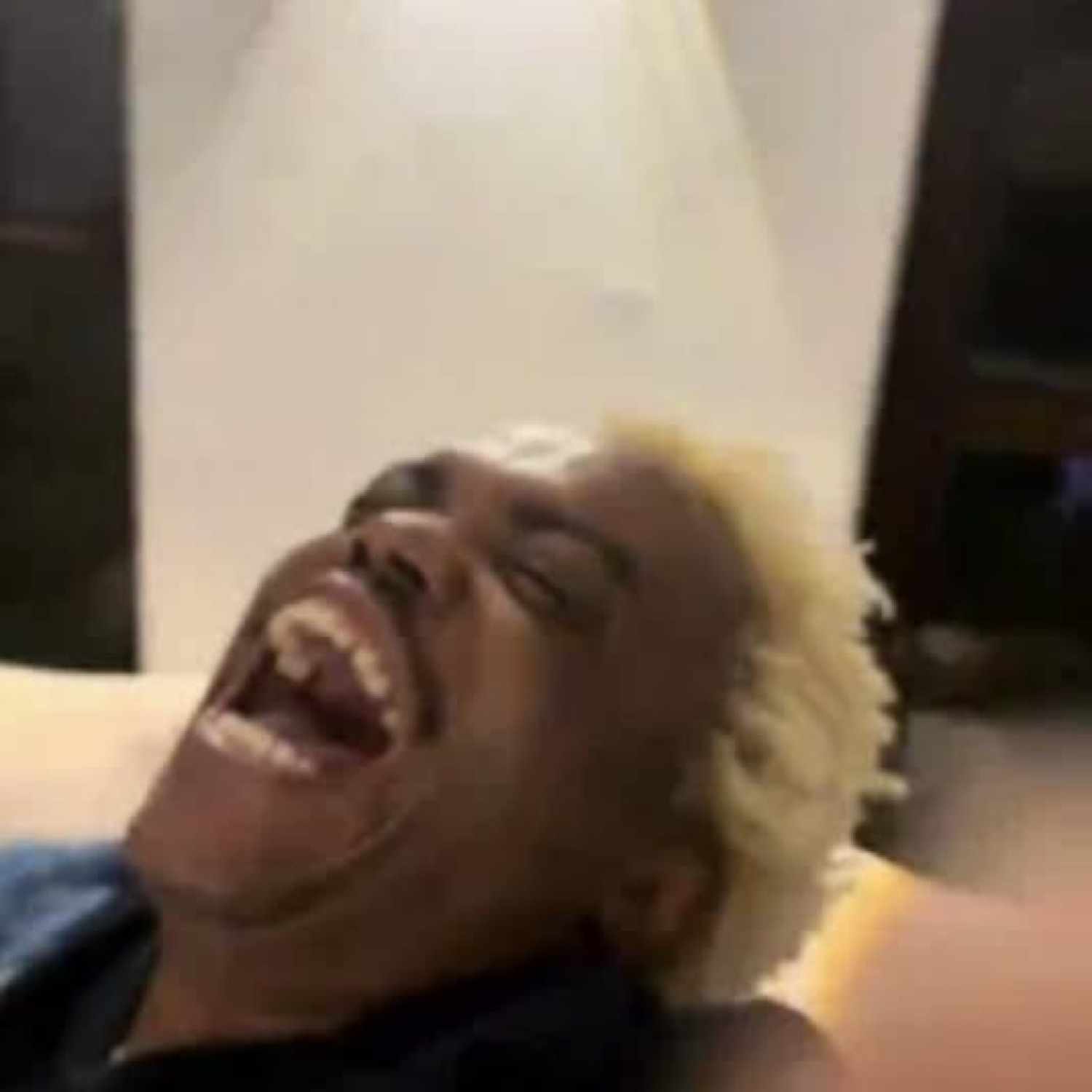 Person with blonde hair thrown back in a full-body ugly laugh