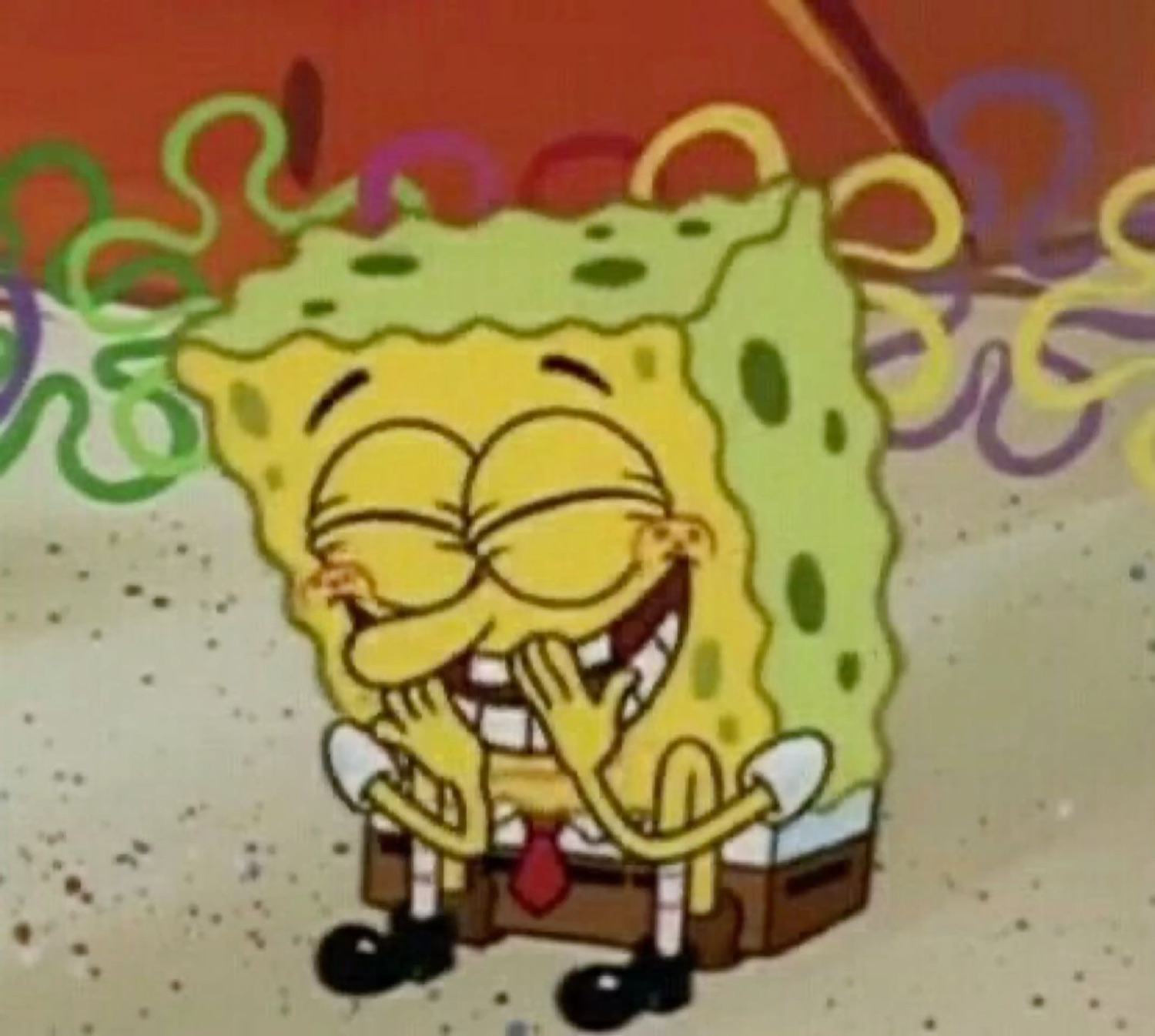 SpongeBob laughing maniacally with hands on cheeks surrounded by confetti