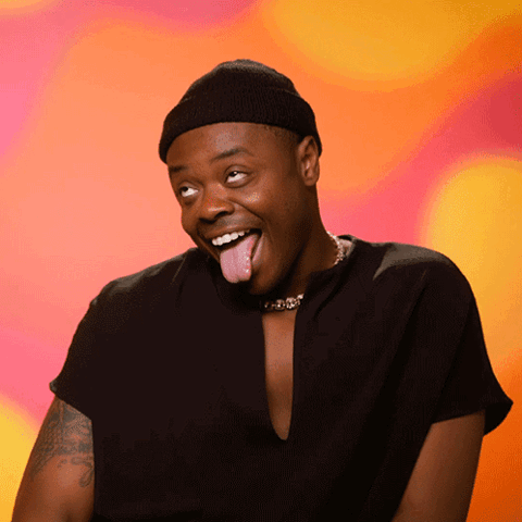 Man in a beanie sticking his tongue out and laughing