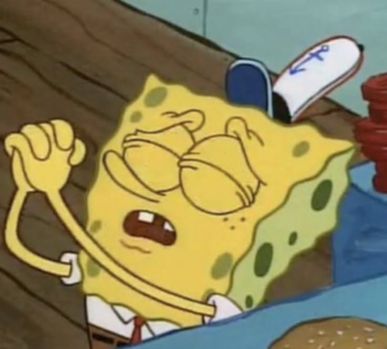 SpongeBob wincing with a clenched fist, looking fed up and irritated