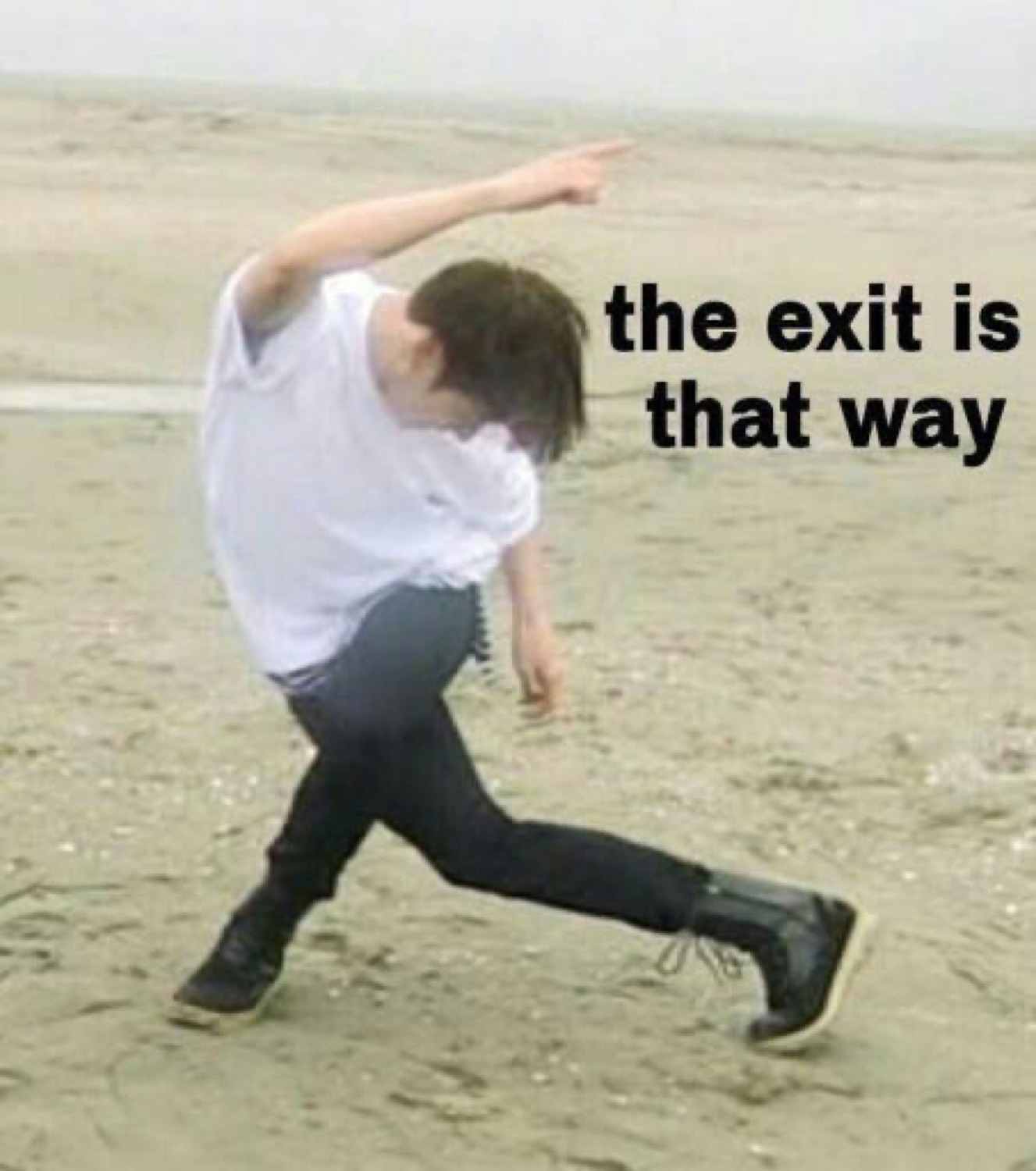 Person on a beach bent over dramatically pointing off-frame, captioned 'the exit is that way'