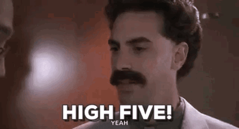 Borat raising his hand and shouting "High five!"