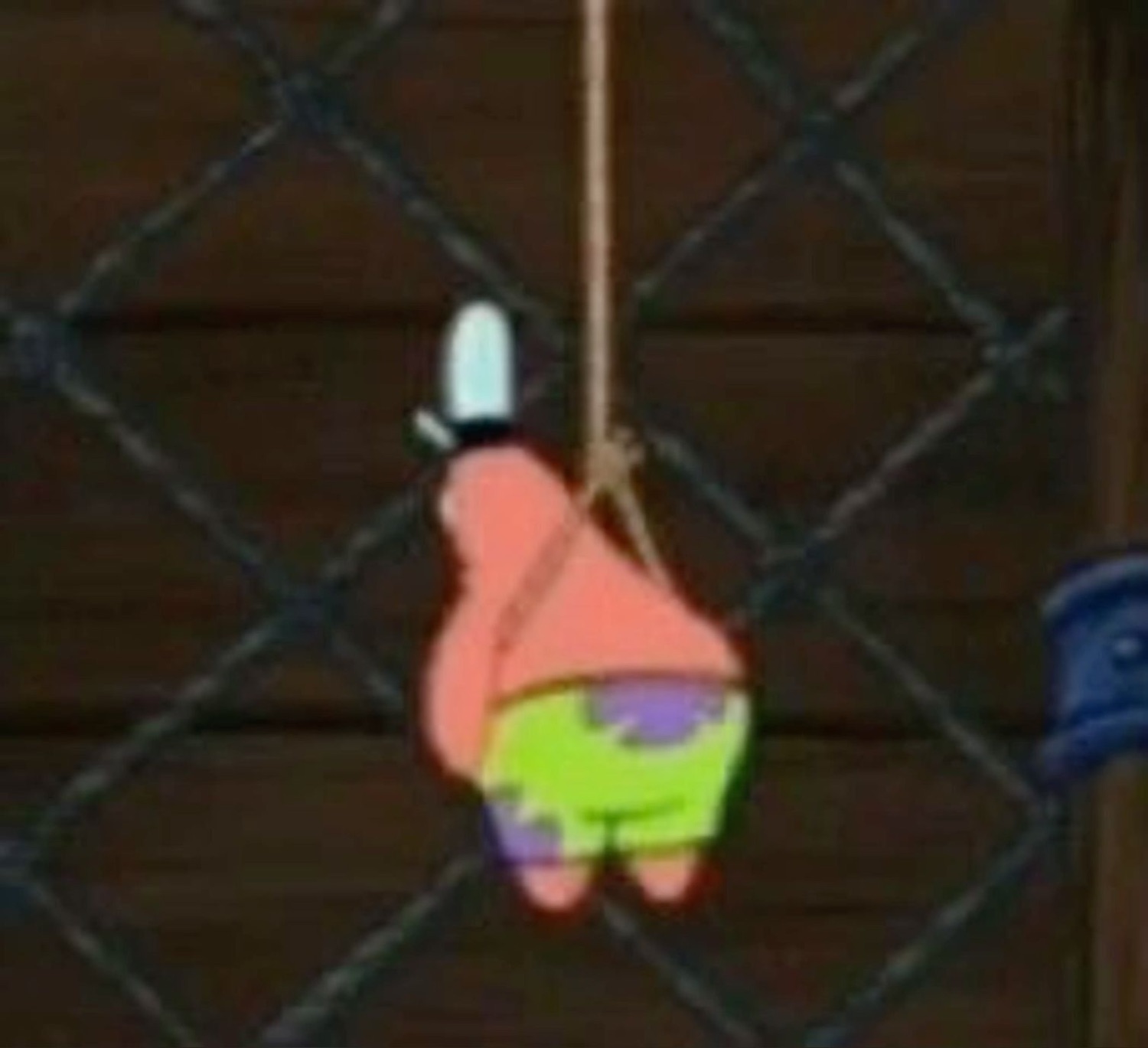 Patrick Star dangling from a rope against a fence, back fully turned