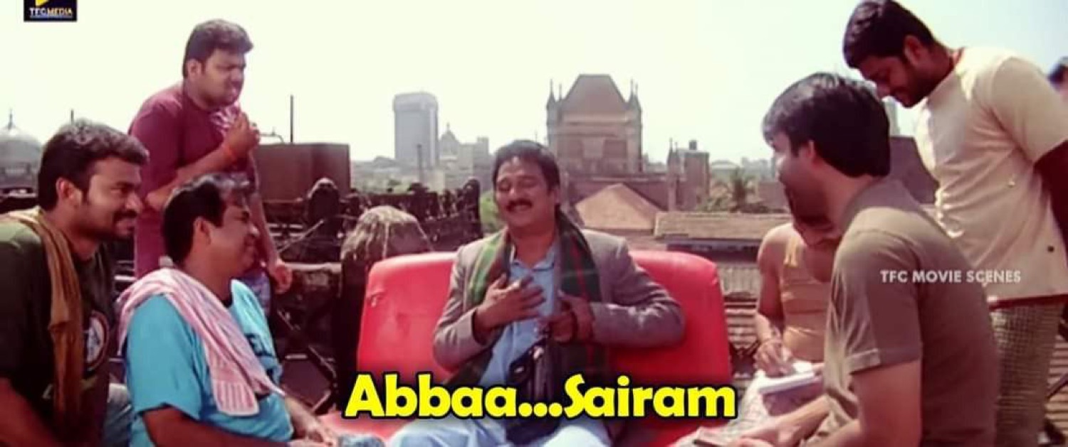 Man in a red car shrugging among a crowd: 'Abbaa...Sairam'