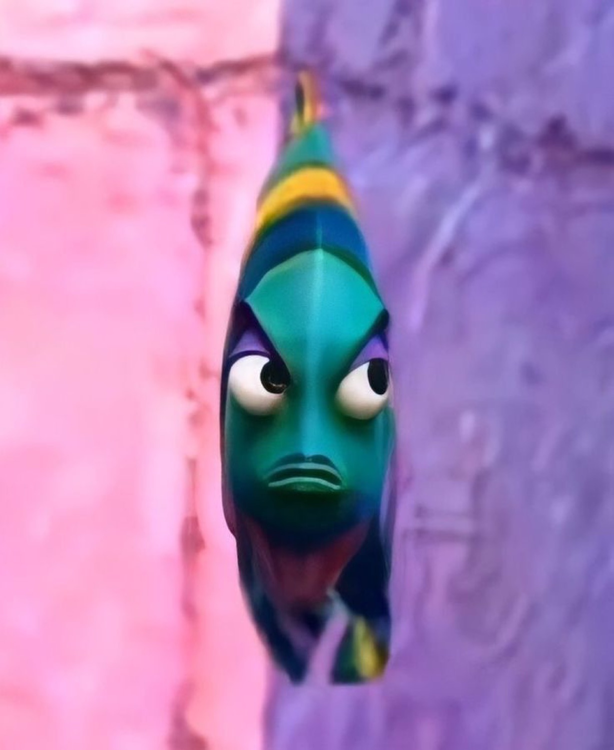 Animated green fish glaring dead ahead with a furious little frown