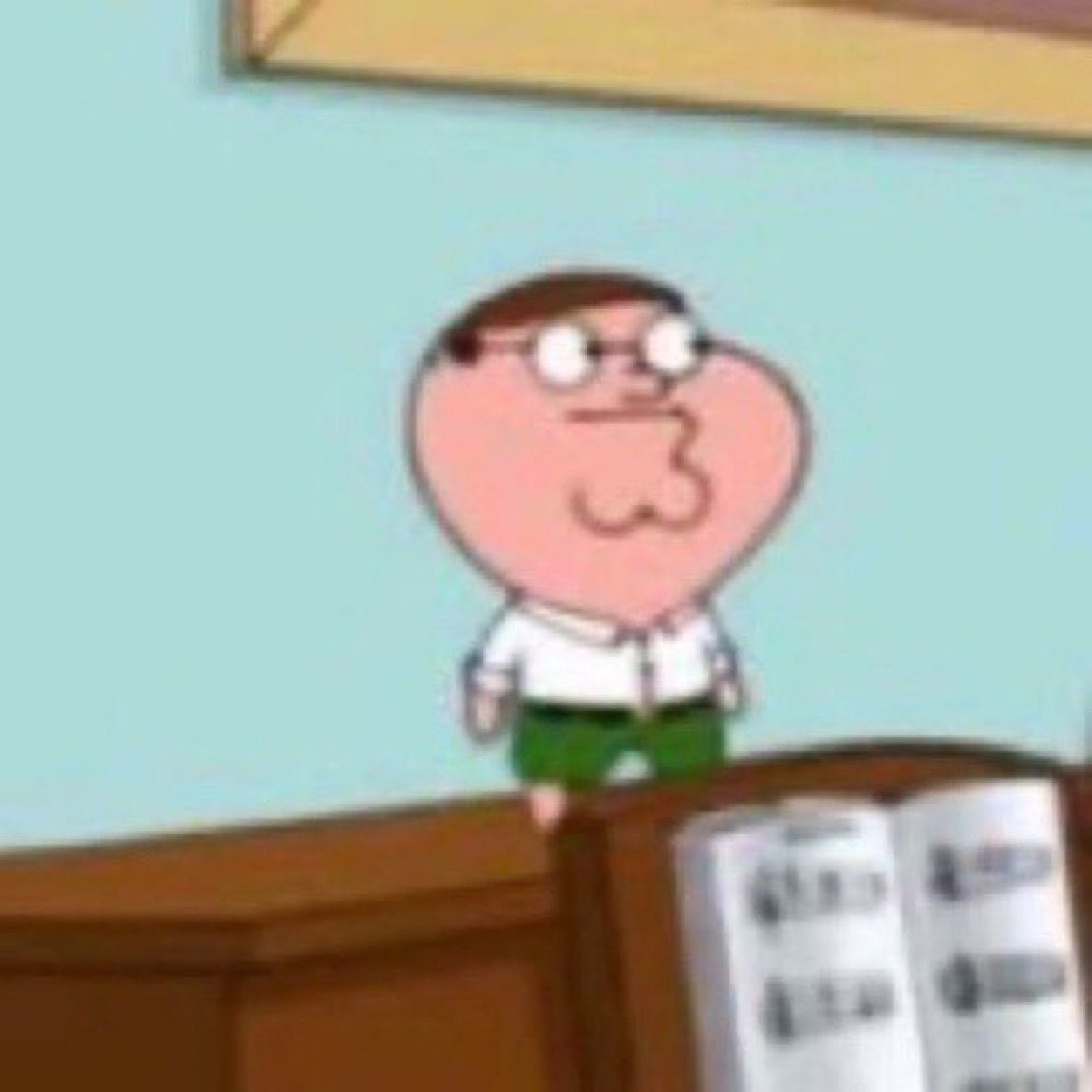 Tiny Peter Griffin sitting smugly at a desk with a book, ready to make a point