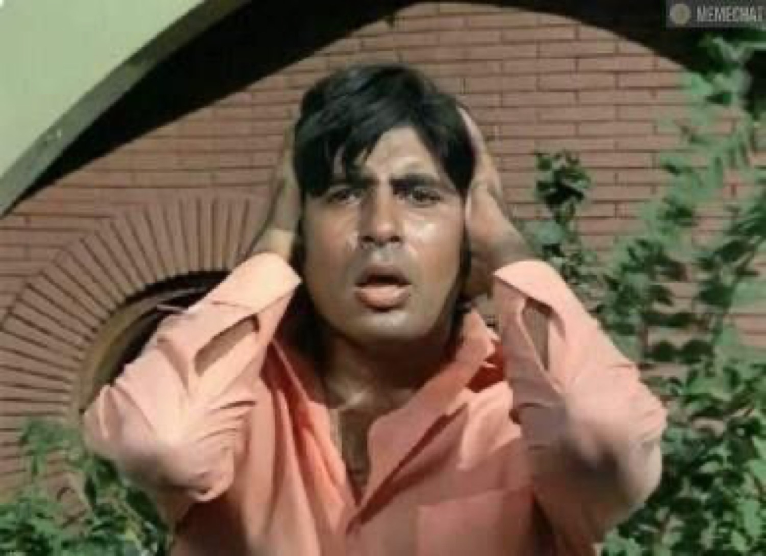 Young Amitabh Bachchan covering his ears in shock