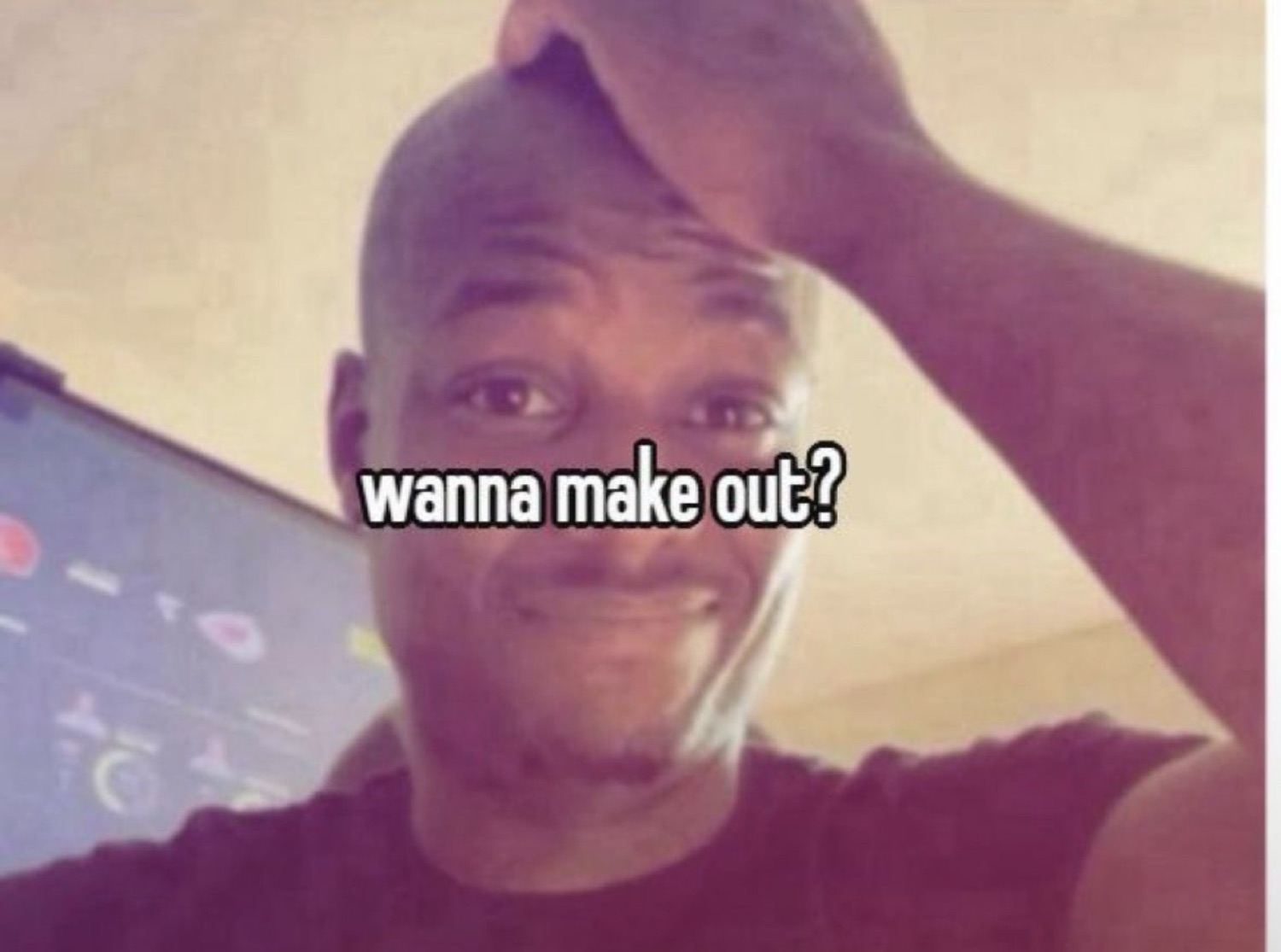 Bald guy smiling shyly with hand on head captioned 'wanna make out?'