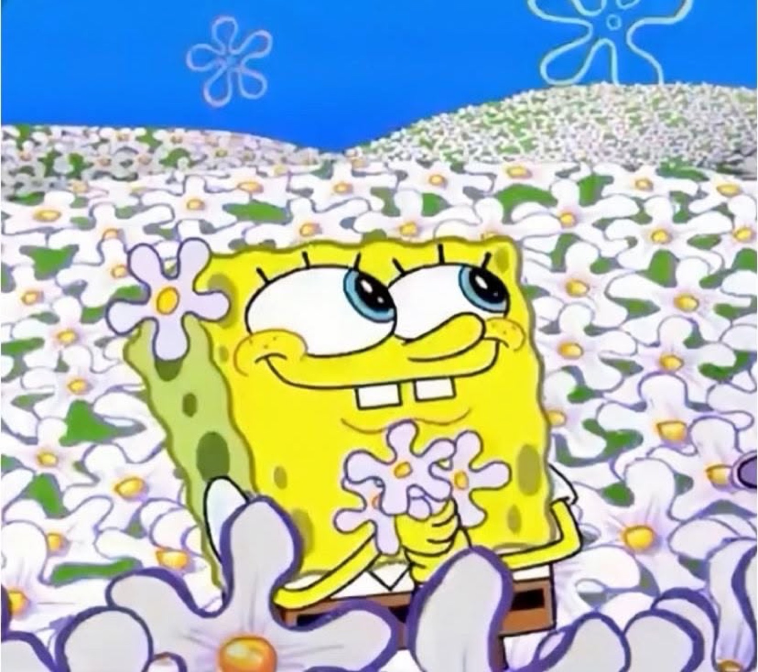 SpongeBob sitting dreamily in a field of flowers with a soft flirty smile