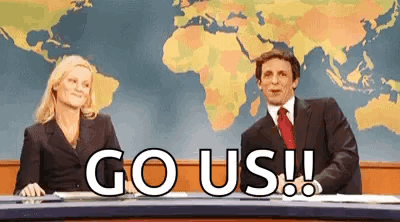 Amy Poehler and Seth Meyers at the Weekend Update desk cheering, "Go us!!"