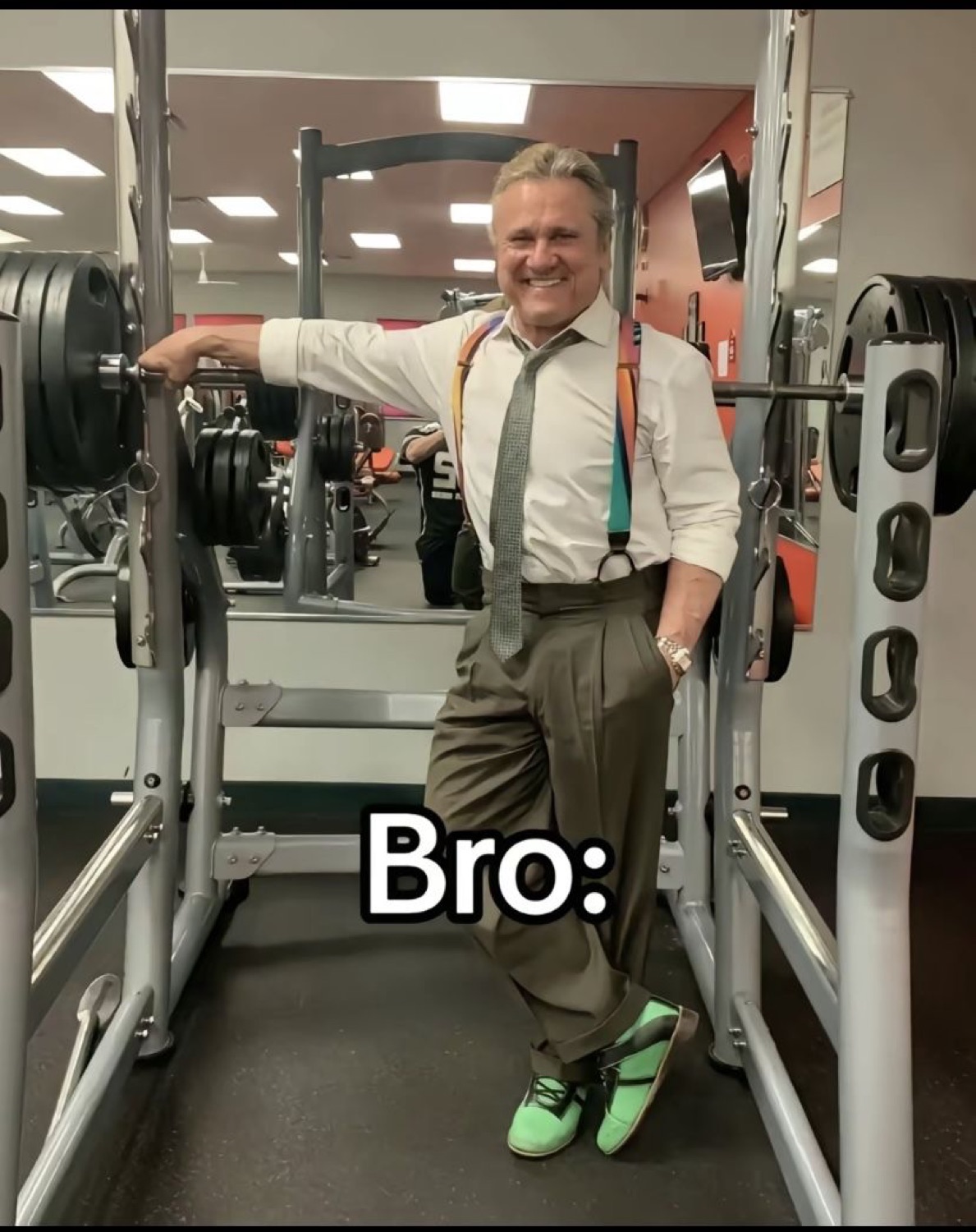 Older man in a tie leaning casually on a squat rack: 'Bro:'