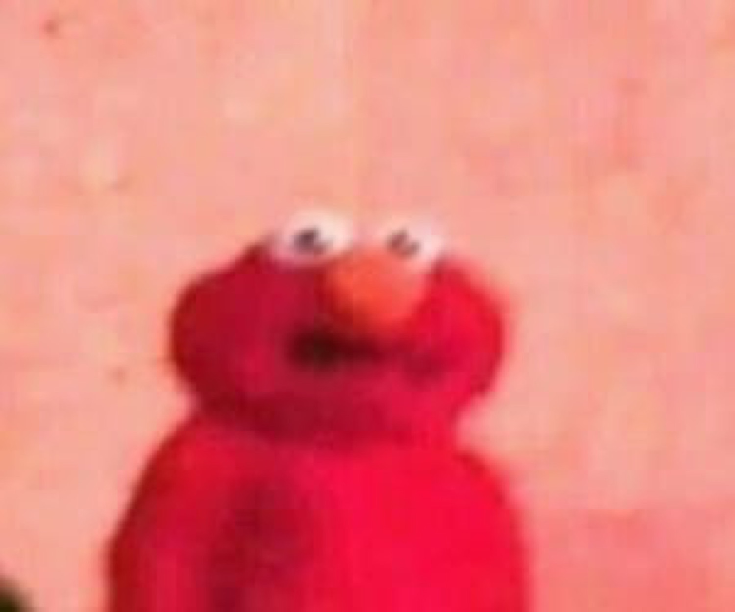 Blurry zoomed-in Elmo with googly eyes giving a vacant stare