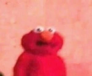 Blurry zoomed-in Elmo with googly eyes giving a vacant stare