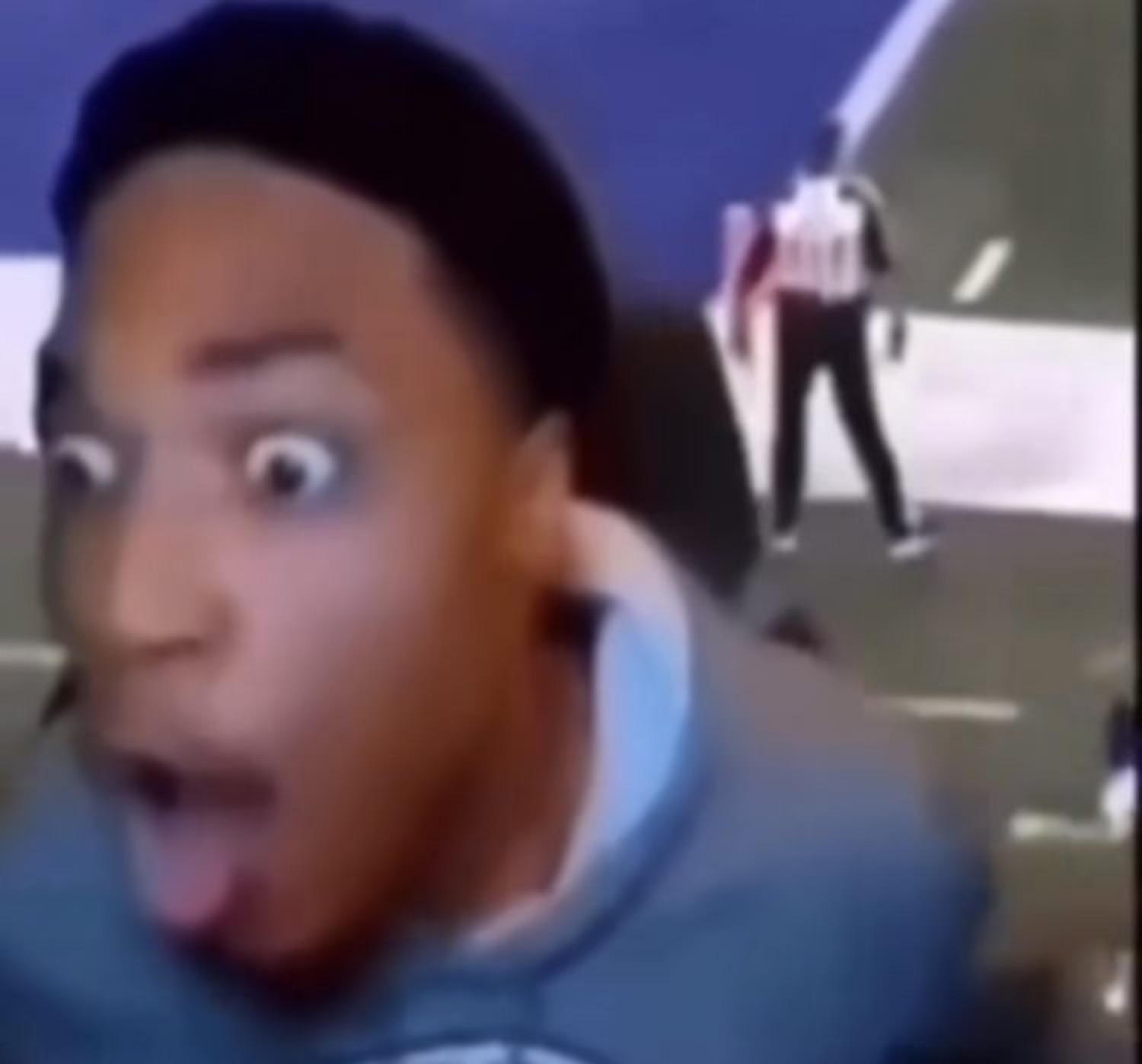 Guy at a football game whipping around to the camera with a shocked, wide-eyed gasp