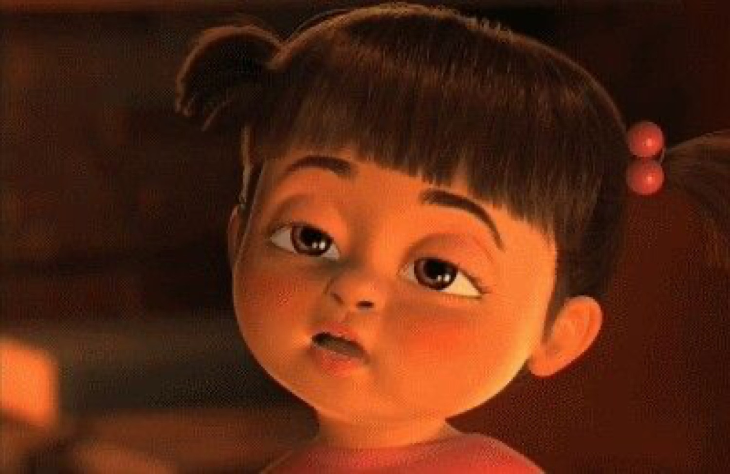 Boo from Monsters Inc. with chubby cheeks and a blank, unimpressed stare